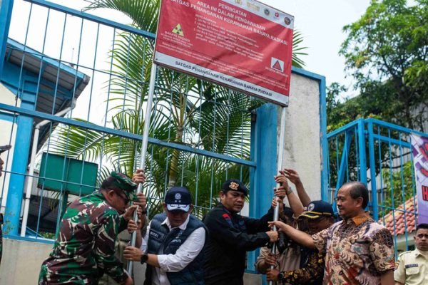Kegiatan simbolis berupa pencabutan plang tanda terkontaminasi yang dilakukan pada Jumat (17/10) oleh Ketua Bidang Diplomasi dan Komunikasi Publik Satgas Cesium-137 Bara Krishna Hasibuan, bersama Deputi Penegakan Hukum Kementerian Lingkungan Hidup Rizal Irawan. Foto: ANTARA FOTO/Muhammad Bagus